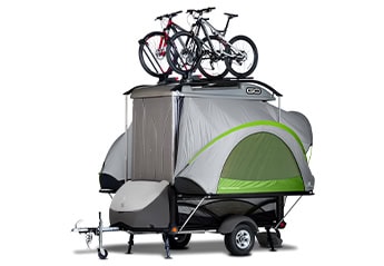 Compact SylvanSport GO trailer with bikes and gear for camping trips.