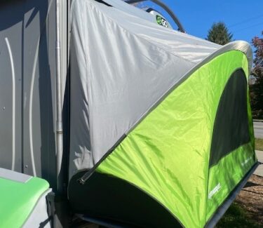Compact SylvanSport Optima camping trailer with pop-up tent for outdoor adventures.