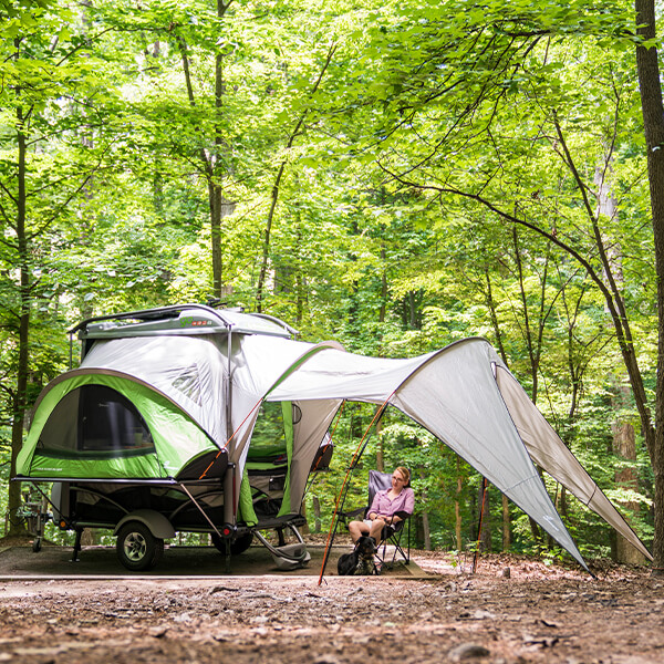 GO Camper trailer with awning and a person sitting below the awning