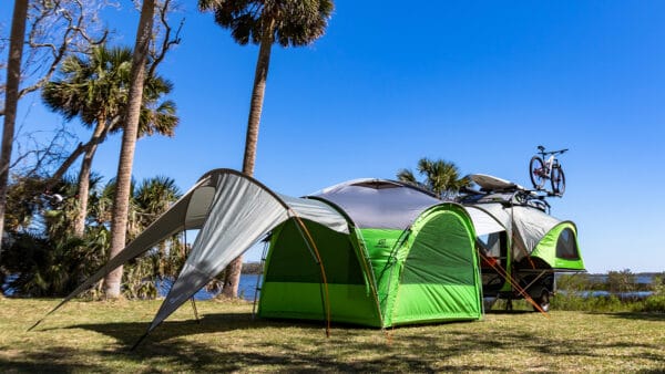 SylvanSport GOzeebo camping tent with accessories in outdoor setting.