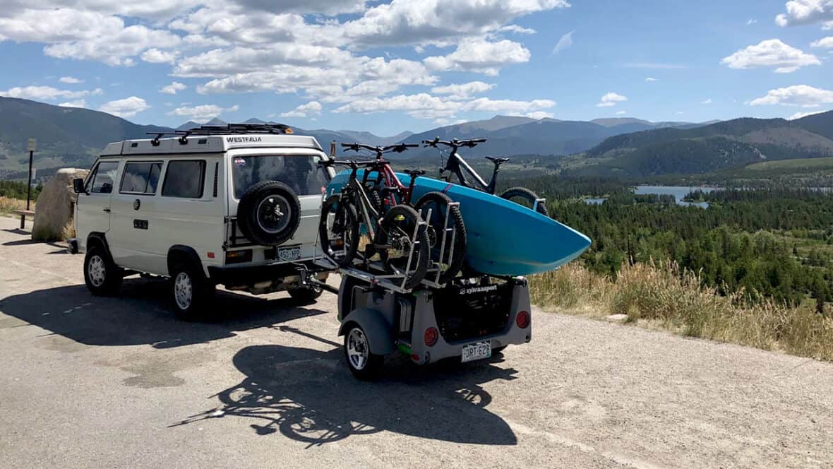 Versatile kayak trailer with bike racks, ideal for outdoor adventures and kayak transportation.