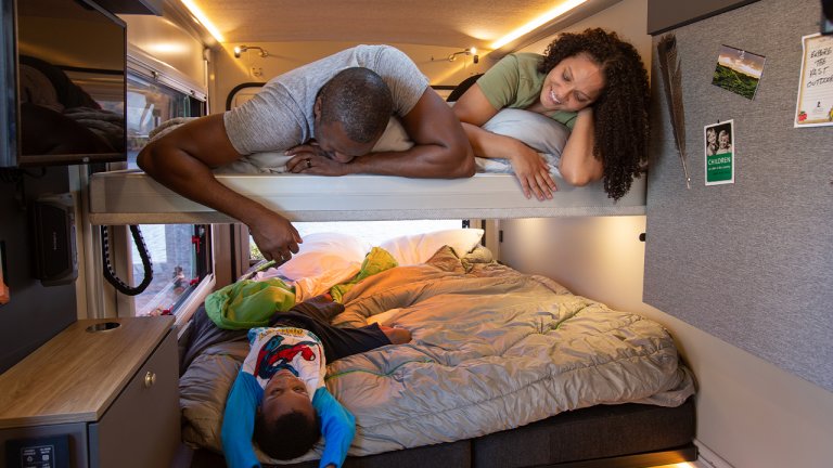 couple on the upper bed and son on the lower bed