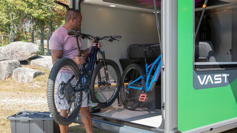 men taking bike from VAST Storage
