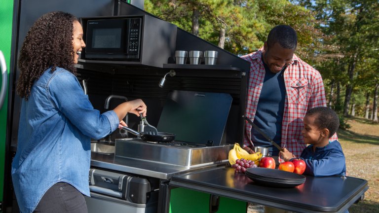 Family cooking outside with VAST retractable kitchen